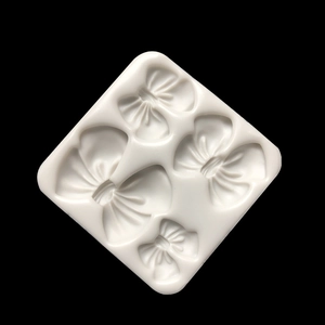 White silicone mold with four different bow shapes for DIY baking and resin crafts