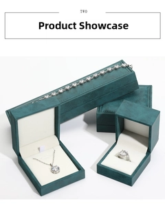 Three-piece silver jewelry set with white crystals in a teal velvet gift box display