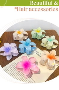 Detail of multi-colored Hawaiian plumeria hair claws in soft pastel acrylic with metal clips