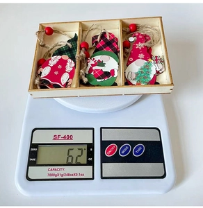 Detailed view of wooden Christmas Gnome ornaments in a storage box on a scale
