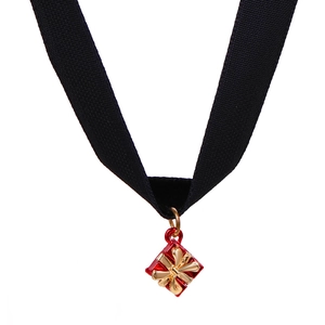 Detail of black velvet choker featuring a small red Christmas gift box pendant with gold bow