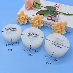 Three translucent flower silicone molds with detailed yellow rose soap crafts on blue base