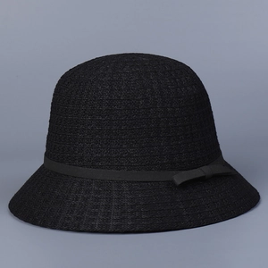 Detail of the elegant black knit sun hat featuring a fine weave and matching ribbon bow