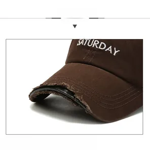 Detail view of SATURDAY embroidery and distressed edges on the vintage baseball cap
