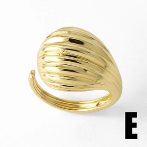Detail of gold-plated adjustable ring featuring a unique ribbed texture and glossy finish