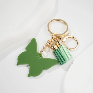 Green butterfly keychain with matching fabric tassels and gold metal hardware