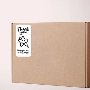 Oval Thank You stickers on kraft box with star illustration for gift packaging