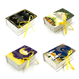 Detail view of four Ramadan gift boxes with moon and star patterns and yellow ribbons