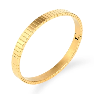 Polished gold stainless steel watch-style hinge bangle with textured horizontal grooves