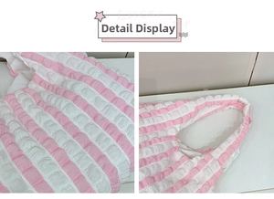 Detail shot of pink and white striped puff fabric on a minimalist ruched cloud handbag