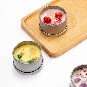 Scented soy candle in tin can with dried flowers and natural crystal stones for decor