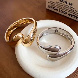 Bracciale rigido a goccia in metallo oro e argento con finitura lucida a specchio