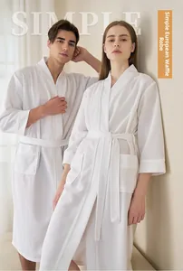 Close-up of white waffle texture fabric with a tied belt and side pocket on a cozy robe