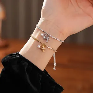 Elegant adjustable zircon bracelet with pearls and cross charms in gold and silver finish