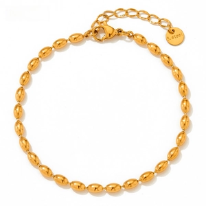 Detailed macro view of gold oval bead bracelet with lobster clasp and adjustable steel chain
