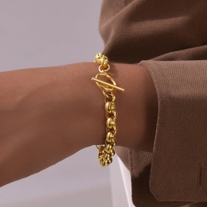 Close-up of gold chunky chain bracelet with T-bar clasp on a wrist for size scale