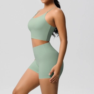 Detail view of mint green high-waisted yoga shorts and fitted cropped sports tank top