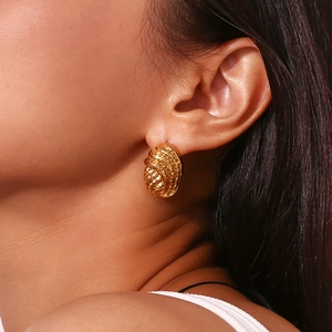 Chic 18K gold plated hammered texture button stud earrings worn by a model