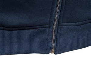 Detail of navy blue knitted fabric with metal zipper and high-density ribbed hem