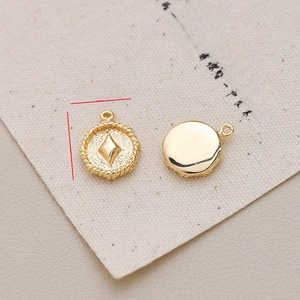 Detail of vintage gold-plated pendant with star engraving and 12mm size markings