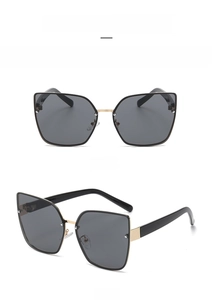 Front and side view of large cat-eye sunglasses with gold bridge and black frames