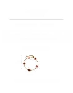 Detailed view of 18k gold-plated flower bracelet with red zircons and fine crystals