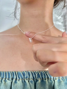 Close-up of 925 sterling silver teardrop zircon necklace worn on woman's neck