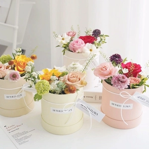 Mini cylindrical floral gift boxes in pink and beige colors for DIY flower arrangements