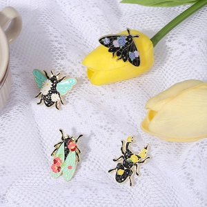 Creative insect alloy brooches featuring floral moth, bee, and beetle on white lace