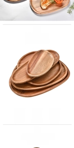 Stack of four acacia wood oval serving trays showing natural grain and food-grade quality