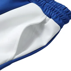 Close-up of contrast stitching and blue-white paneled side pockets on jogging pants