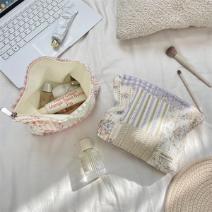 Detailed view of floral quilted makeup bags with wide opening for easy organization