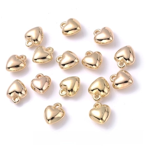 Macro shot of 15x17mm polished gold heart pendants with rings for jewelry DIY making