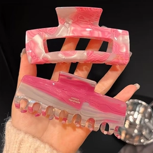 Pink and white marble heart claw clips made of acetate for elegant hair styling