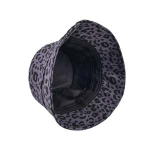 Top-down view of a grey leopard print bucket hat with black lining and cotton texture