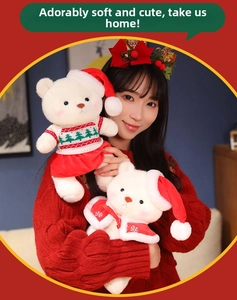 Close-up of white plush Christmas teddy bears wearing knitted sweaters and Santa hats