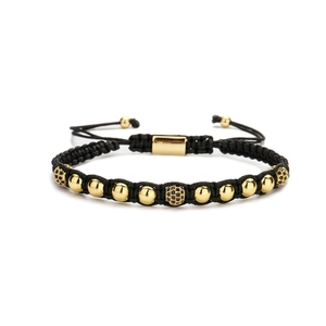 Handcrafted woven bracelet with gold beads and black cubic zirconia adjustable cord