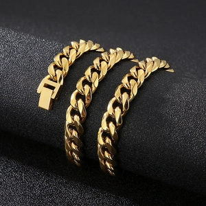 Detailed close-up of golden stainless steel Cuban link bracelet with glossy finish