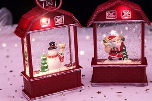 Close-up of lighted Santa Claus and Snowman water globes in red house-shaped lanterns