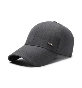 Detail of dark grey baseball cap featuring textured fabric and metal side branding