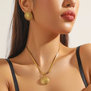 Gold plated vintage woven texture necklace and earrings set worn by model