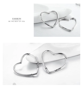 Macro view of s925 sterling silver heart earrings with LOVED engraving and metal finish