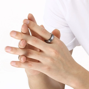 Close-up of men's brushed dark gray tungsten steel ring with a smooth matte finish