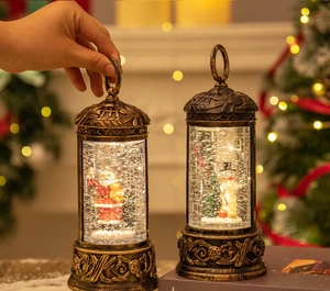Close-up of vintage Christmas snow globe lantern with santa and snowman figurines