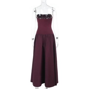 Detail of burgundy strapless dress featuring a fitted bodice and voluminous flared skirt