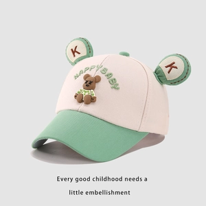 Detail of pink and green kids baseball cap with 3D teddy bear and HAPPY BABY embroidery