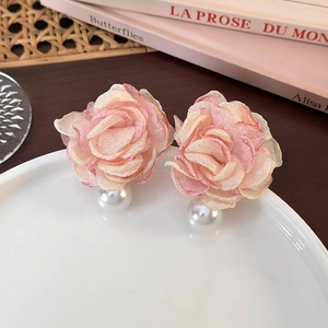 Pink chiffon flower earrings with pearls on a porcelain plate in a French vintage style