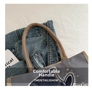 Close-up of durable woven rope handles on a skull canvas tote bag with detailed stitching