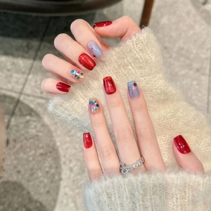 Deep red and light blue cat-eye press-on nails with cherry and glitter bow charms