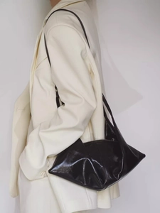Minimalist black oil wax leather crescent shoulder bag with a unique folded design